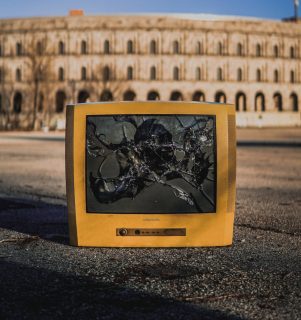 Broken TV screen on the ground