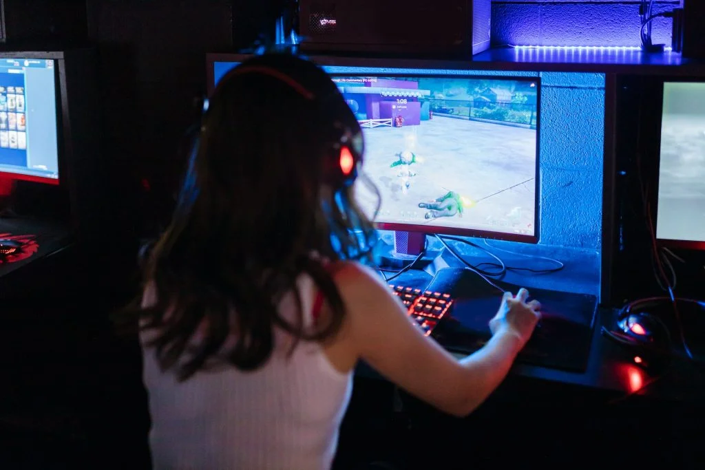 Woman gaming on bright gaming monitor