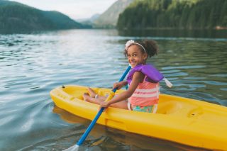 a happy little girl in a kayak at the lake in summ 2022 03 06 13 18 51 utc