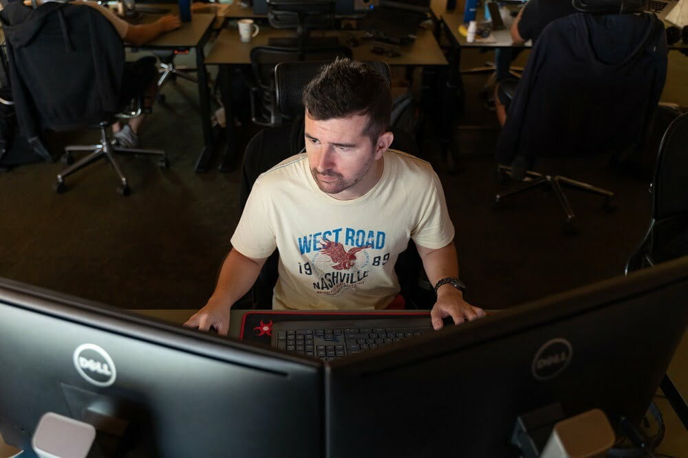 man using two computer monitors