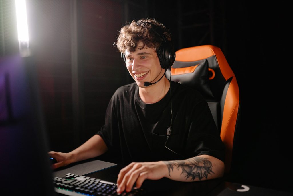 man playing video game with gaming headset and mic