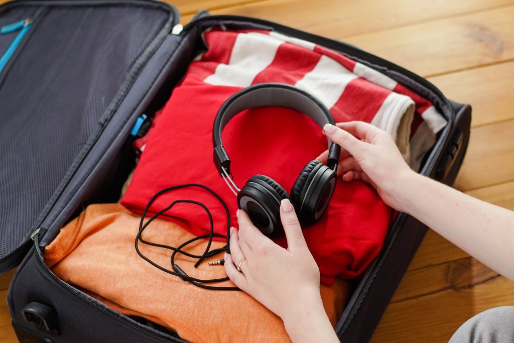 woman put black headphones in a suitcase with clot 2022 10 14 17 43 05 utc